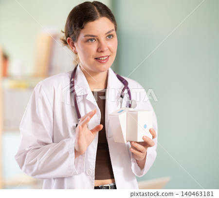 female doctor is standing in her office, she talks about vitamins female doctor is standing in her office, she talks about vitamins 140463181