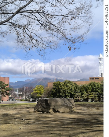 A pleasant winter day. Wakasato Park in Nagano City offers a calming atmosphere with its large stones and spacious surroundings. A pleasant winter day. Wakasato Park in Nagano City offers a calming atmosphere with its large stones and spacious surroundings. 140463251