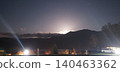 The moon rising over the mountains at night 140463362