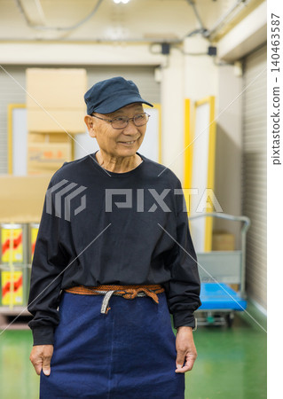 Senior working men wearing canvas aprons Senior working men wearing canvas aprons 140463587