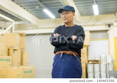 Senior working men wearing canvas aprons Senior working men wearing canvas aprons 140463598