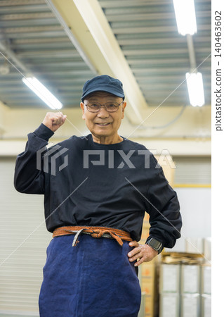 Senior working men wearing canvas aprons Senior working men wearing canvas aprons 140463602