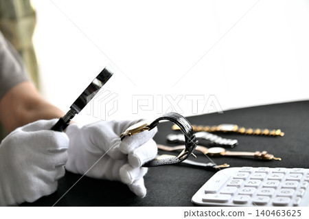 Image of an appraiser evaluating a watch Image of an appraiser evaluating a watch 140463625