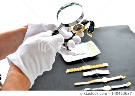 Image of an appraiser evaluating a watch Image of an appraiser evaluating a watch 140463627