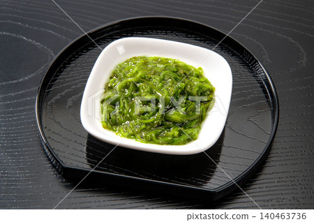 Japanese food wakame seaweed on a black background. Japanese food wakame seaweed on a black background. 140463736
