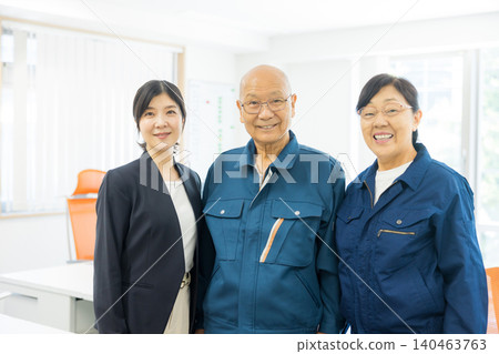 Senior man in work clothes strikes a triumphant pose. Senior man in work clothes strikes a triumphant pose. 140463763