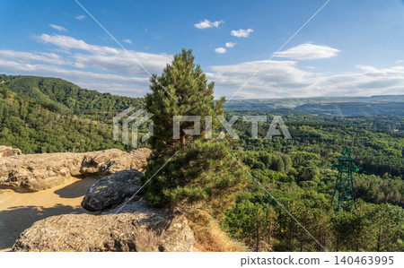 Majestic rocky cliffs and towering pine trees against blue sky. Majestic rocky cliffs and towering pine trees against blue sky. 140463995
