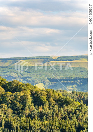 Layers of green mountains and hills in the haze during sunset. Panoramic View of Green hills and Meadow. Layers of green mountains and hills in the haze during sunset. Panoramic View of Green hills and Meadow. 140463997
