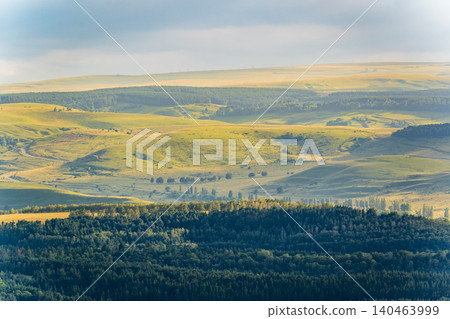 Layers of green mountains and hills in the haze during sunset. Panoramic View of Green hills and Meadow. Layers of green mountains and hills in the haze during sunset. Panoramic View of Green hills and Meadow. 140463999