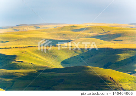 Layers of green mountains and hills in the haze during sunset. Panoramic View of Green hills and Meadow. 140464006