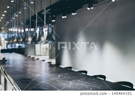 Unmanned counter seating and restaurant interior with pendant lights lined up. Unmanned counter seating and restaurant interior with pendant lights lined up. 140464191
