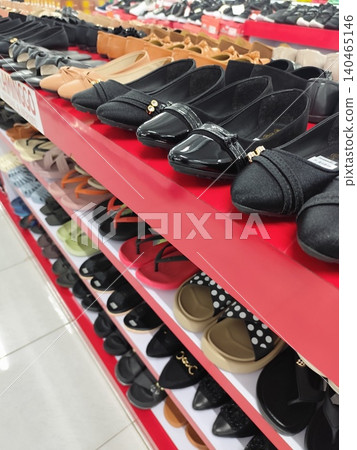 Women's shoes and sandals neatly arranged on shelves, photo taken in a supermarket Women's shoes and sandals neatly arranged on shelves, photo taken in a supermarket 140465146