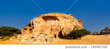 Panoramic view of the ancient Nabatean tombs carved into the sandstone cliffs of Jabal Al Banat in Hegra, Al Ula, Saudi Arabia, a UNESCO World Heritage site. Panoramic view of the ancient Nabatean tombs carved into the sandstone cliffs of Jabal Al Banat in Hegra, Al Ula, Saudi Arabia, a UNESCO World Heritage site. 140465505