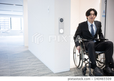 A young businessman who uses a wheelchair to work in the office; accessibility features in the company's restrooms, etc. A young businessman who uses a wheelchair to work in the office; accessibility features in the company's restrooms, etc. 140465509