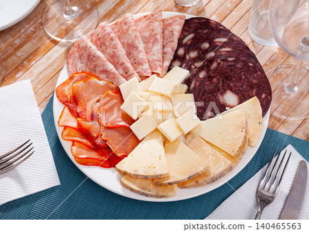 Slicing of smoked sausage, ham, dried pork carbonade and cheese Slicing of smoked sausage, ham, dried pork carbonade and cheese 140465563