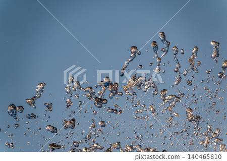 Splashes and jets of water against light background. 140465810