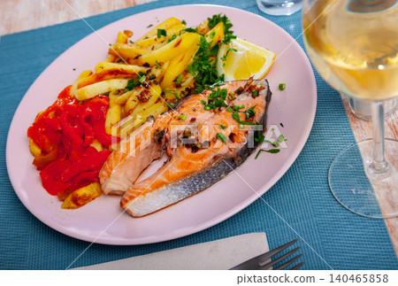 Salmon steak with fried potato, red pepper and slice of lemon Salmon steak with fried potato, red pepper and slice of lemon 140465858