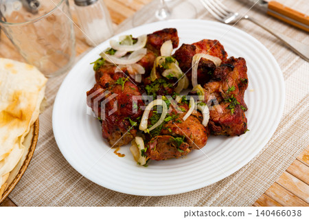 Barbecued pork shashlik with onion and herbs 140466038