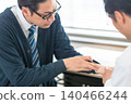 A male patient in a tie complaining of pain in a hospital examination room. 140466244