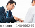 A male patient in a tie complaining of pain in a hospital examination room. 140466245