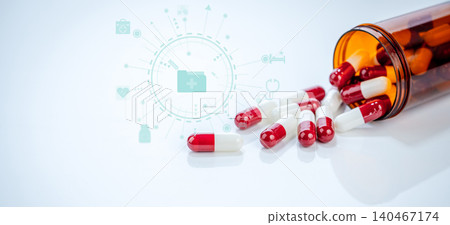 Red white capsules spilling from plastic bottle on white background. Prescription drugs and pharmaceutical regulations. Safety standards and efficacy requirements in modern healthcare. Health policy. Red white capsules spilling from plastic bottle on white background. Prescription drugs and pharmaceutical regulations. Safety standards and efficacy requirements in modern healthcare. Health policy. 140467174