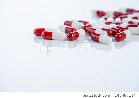 Red white capsules scattered on white background illustrate drug discovery journey from laboratory to market. Pharmaceutical innovation process and rigorous approval stages for new medications Red white capsules scattered on white background illustrate drug discovery journey from laboratory to market. Pharmaceutical innovation process and rigorous approval stages for new medications 140467184