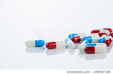 Red white and blue white antibiotic capsules pill arranged to concern of antibiotic associated adverse events and toxicity risks in modern healthcare practices and patient safety considerations. Red white and blue white antibiotic capsules pill arranged to concern of antibiotic associated adverse events and toxicity risks in modern healthcare practices and patient safety considerations. 140467186
