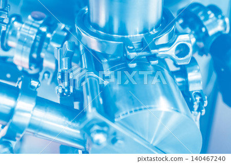 Stainless steel valves and safety lock mechanisms in modern food processing facility. Industrial grade sanitary equipment for quality control and hygienic manufacturing process. Industrial machinery. Stainless steel valves and safety lock mechanisms in modern food processing facility. Industrial grade sanitary equipment for quality control and hygienic manufacturing process. Industrial machinery. 140467240
