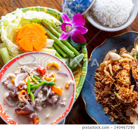 Top view of salted crab dip with coconut milk and vegetables in Thai luxury restaurant. Thai cuisine. Luxury dining experience. Healthy salted crab dip with fresh vegetables. Traditional Thai gourmet. Top view of salted crab dip with coconut milk and vegetables in Thai luxury restaurant. Thai cuisine. Luxury dining experience. Healthy salted crab dip with fresh vegetables. Traditional Thai gourmet. 140467290