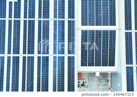 Solar energy for factory and warehouse building. Solar panels on roof of industrial plant. Commercial solar power. Rooftop solar power. Rooftop renewable energy system. Sustainable green energy. 140467323
