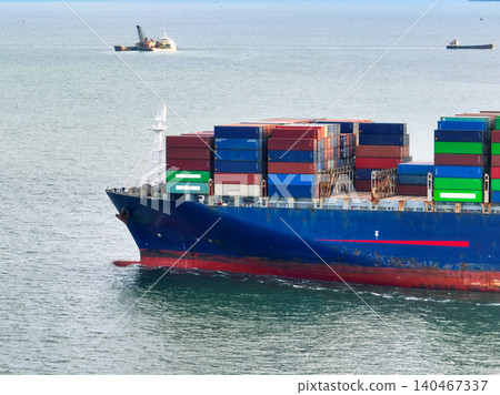 Aerial view of container cargo ship at sea. International shipping and logistics. Maritime freight transportation. Global trade and export import industry. Commercial vessel carrying containers. Aerial view of container cargo ship at sea. International shipping and logistics. Maritime freight transportation. Global trade and export import industry. Commercial vessel carrying containers. 140467337