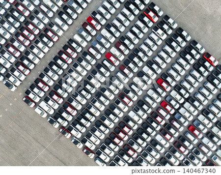 Aerial view of new cars stock at factory parking lot. Above view cars parked in a row. Automotive industry. Logistics business. Import or export new cars at warehouse. Big parking lot at port terminal 140467340