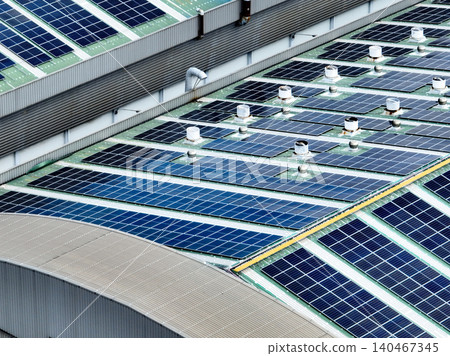 Rooftop solar panels on an industrial plant building. Clean and renewable power solutions, green energy innovation, and sustainable commercial electricity generation. Sustainable manufacturing. Rooftop solar panels on an industrial plant building. Clean and renewable power solutions, green energy innovation, and sustainable commercial electricity generation. Sustainable manufacturing. 140467345