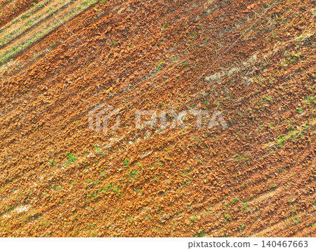 Aerial view of agriculture plowed field. Minimal tillage for healthier soils. Fertile soil in organic agricultural farm. Soil conservation. Sustainable agriculture. Soil fertility. Plowed land. 140467663