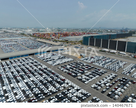 Aerial view of new cars stock at factory parking lot. Above view cars parked in a row. Automotive industry. Logistics business. Import or export new cars at warehouse. Big parking lot at port terminal 140467671