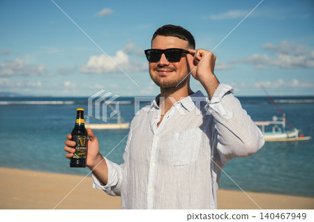 Bali, Indonesia, March 18, 2026: Guinness drink at the beach Bali, Indonesia, March 18, 2026: Guinness drink at the beach 140467949