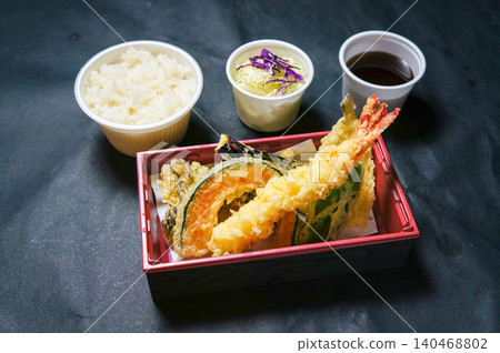 A colorful tempura bento box set featuring vegetables and shrimp. 140468802