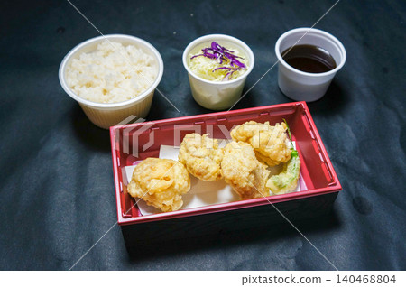 A classic bento box: a set of chicken tempura and rice. A classic bento box: a set of chicken tempura and rice. 140468804