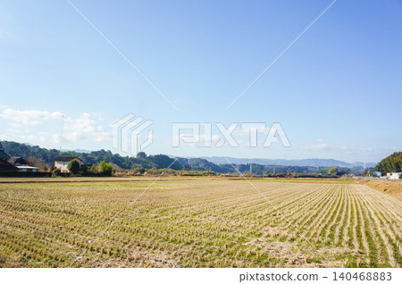 A landscape of blue skies and sprawling rice fields seen in winter in Kumamoto. A landscape of blue skies and sprawling rice fields seen in winter in Kumamoto. 140468883