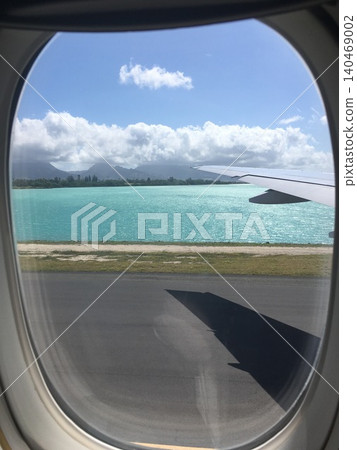 The tropical sea and runway as seen from the airplane window 140469002