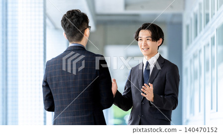 Two male businessmen talking Two male businessmen talking 140470152