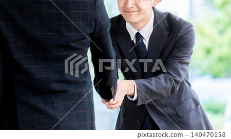 two male businessmen shaking hands two male businessmen shaking hands 140470158
