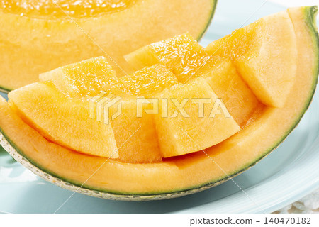 A close-up of the flesh of a red-fleshed melon, a mouthwatering photo of a perfectly ripe melon with seeds and juice oozing out. A close-up of the flesh of a red-fleshed melon, a mouthwatering photo of a perfectly ripe melon with seeds and juice oozing out. 140470182