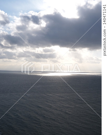 A seascape illuminated by light filtering through the clouds 140471141