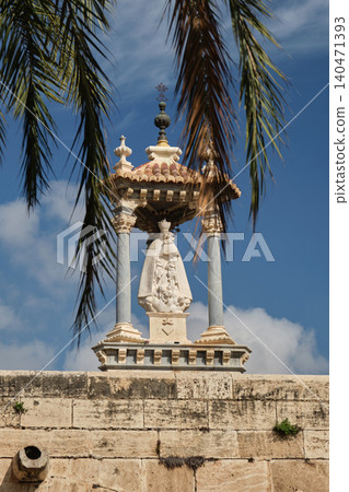 Historic Religious Monument Framed by Palm Trees Under Blue Sky Historic Religious Monument Framed by Palm Trees Under Blue Sky 140471393