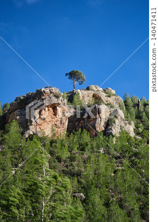 a rock against the blue sky a rock against the blue sky 140471411