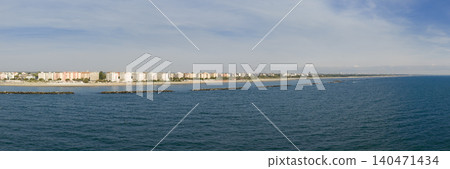 Panorama view of sandy beach with umbrellas and gazebos.Summer vacation concept.Lido Adriano town,Adriatic coast, Emilia Romagna,Italy. Panorama view of sandy beach with umbrellas and gazebos.Summer vacation concept.Lido Adriano town,Adriatic coast, Emilia Romagna,Italy. 140471434