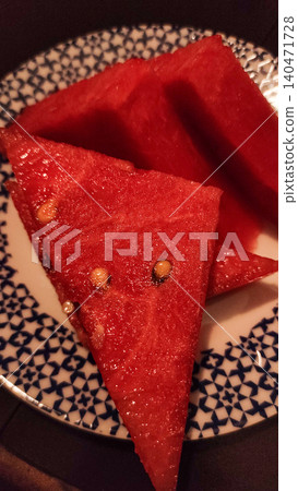 Slices of refreshing watermelon resting on decorative plate in summer Slices of refreshing watermelon resting on decorative plate in summer 140471728