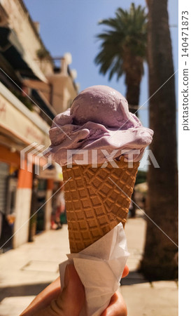 Lavender ice cream cone enjoyed on croatian vacation during summer Lavender ice cream cone enjoyed on croatian vacation during summer 140471873