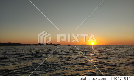 Sunset over adriatic sea in croatia with sailboats at dusk during summer vacation Sunset over adriatic sea in croatia with sailboats at dusk during summer vacation 140471915